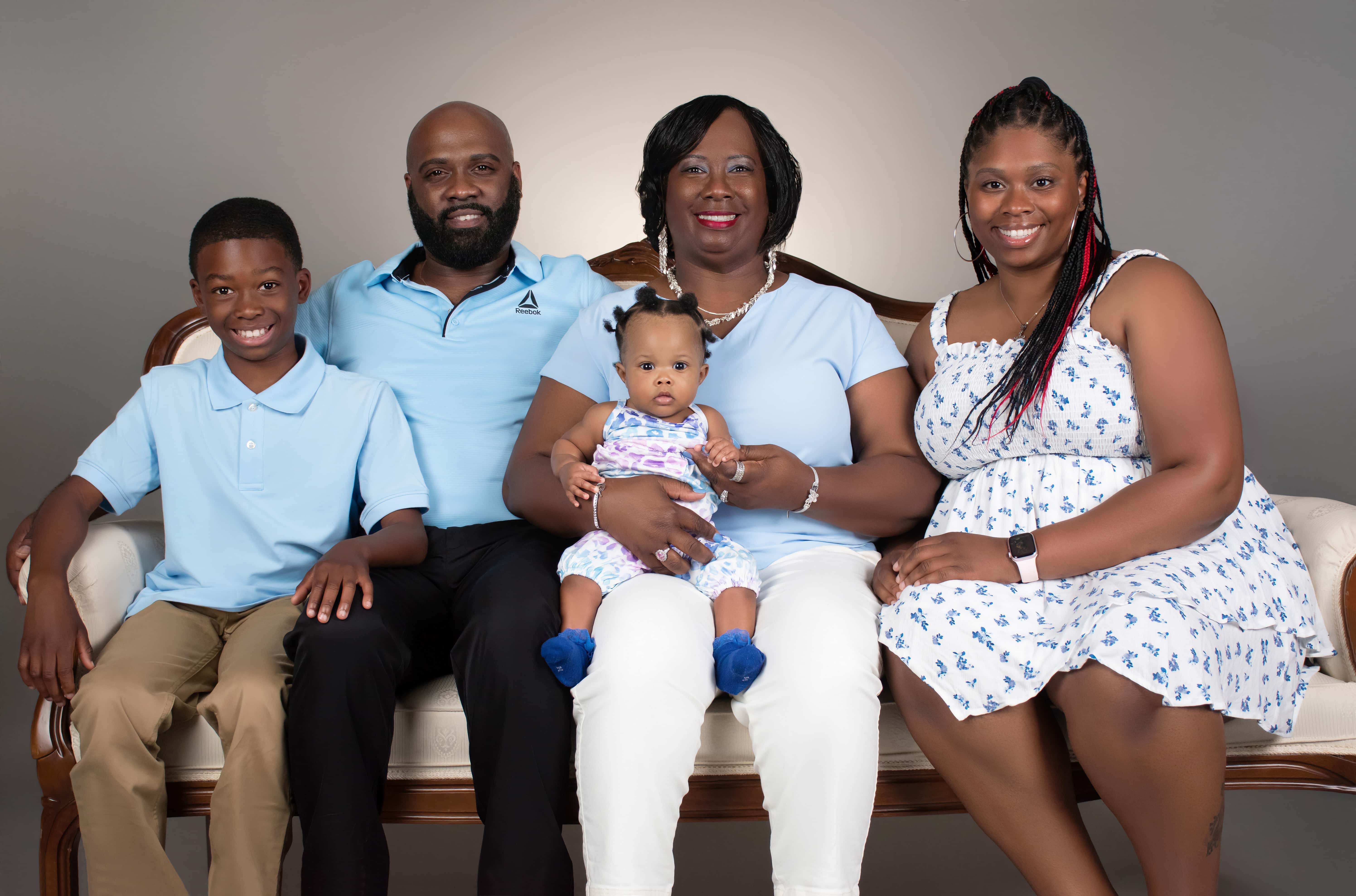 Three-generation family portrait with grandmother holding baby in the DP Photography LLC studio in Biloxi, MS