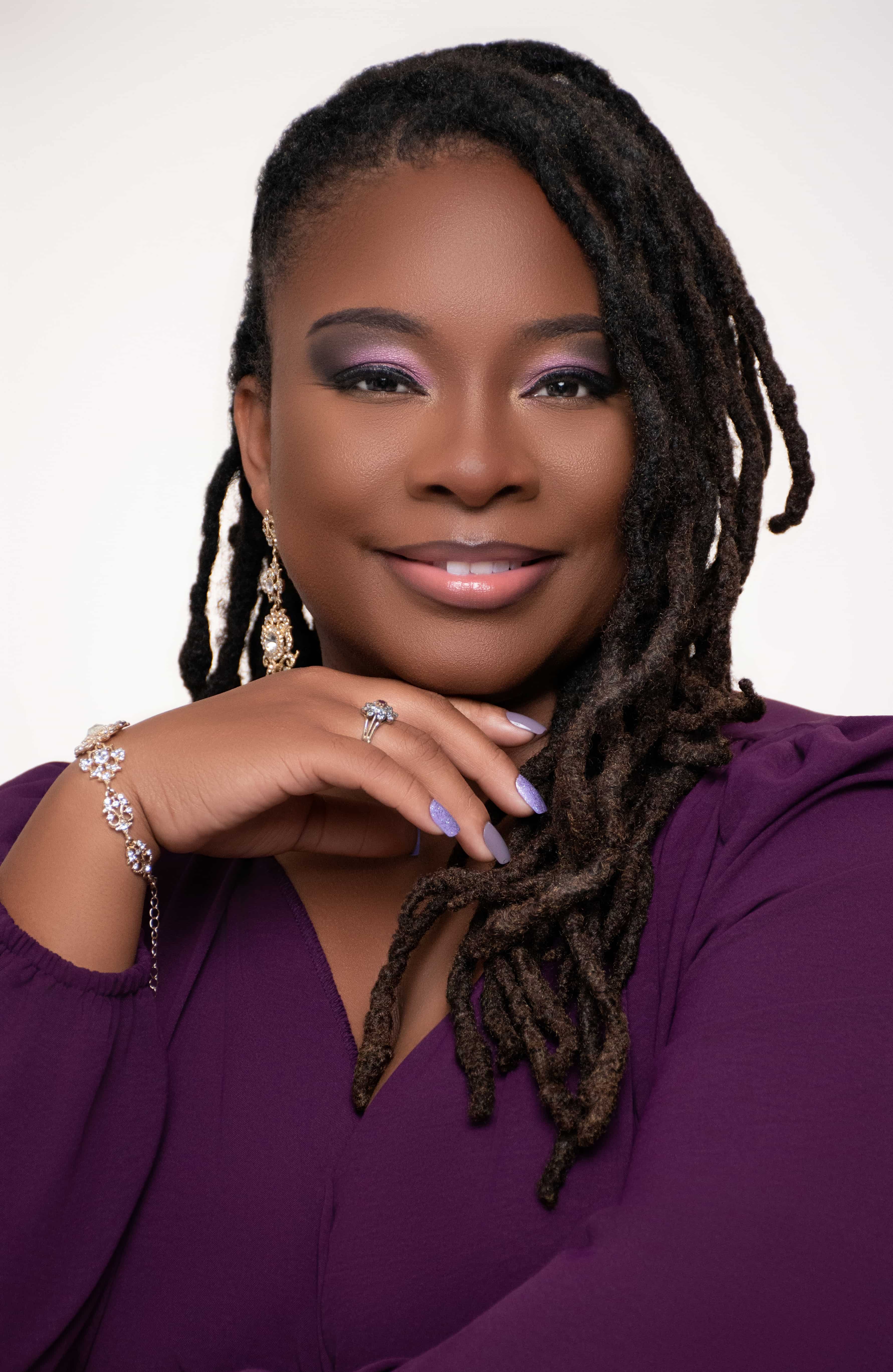 Personal brand headshot in purple with a hand-to-chin pose by DP Photography LLC, Biloxi